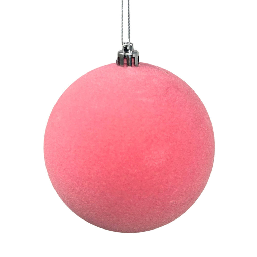 Pink Christmas ornament on a white background