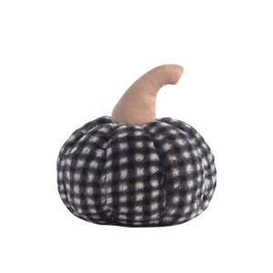 A medium-sized faux fur pumpkin-shaped pillow with a black and white checkered pattern.