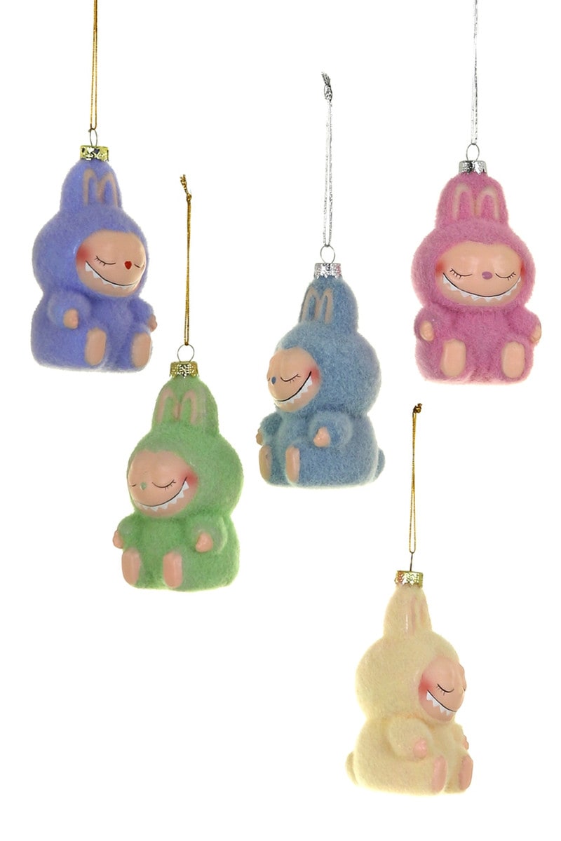 Set of colorful cartoon-like character ornaments hanging on a white background