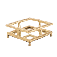 Gold decorative tray with a geometric design on a white background