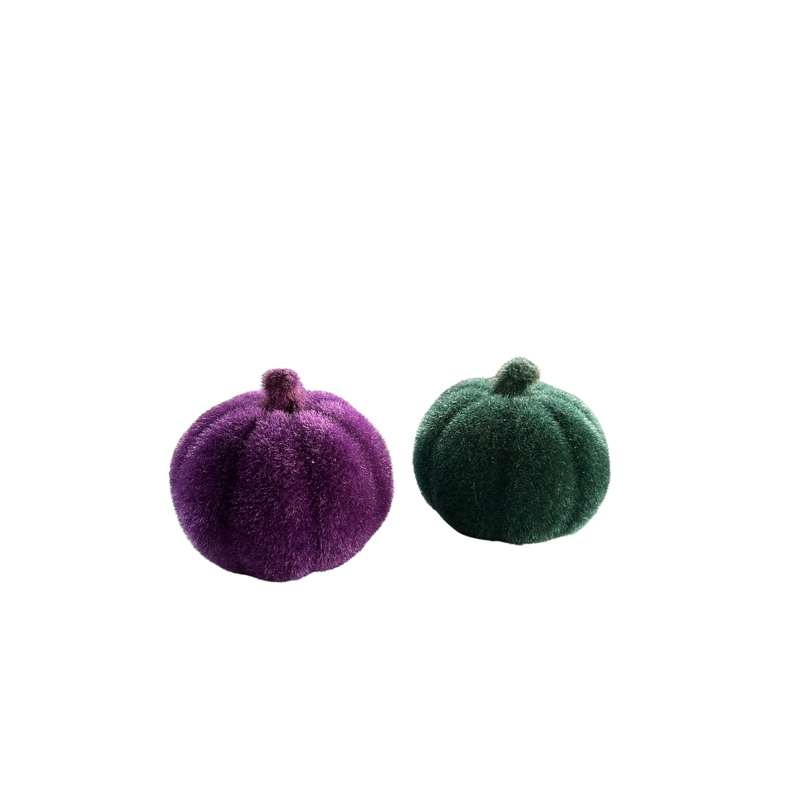 Two felt pumpkins, one purple and one green, on a white background