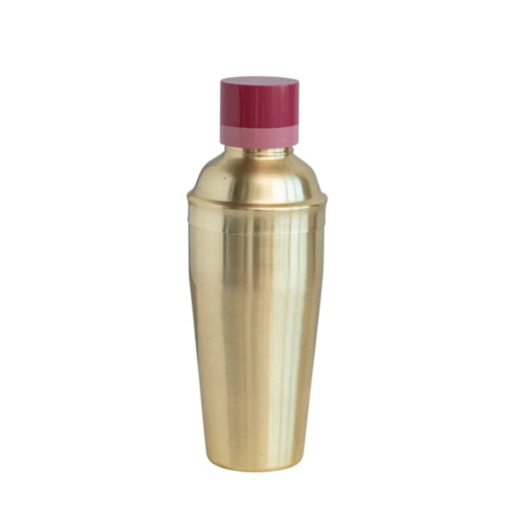 Gold cocktail shaker with a red cap on a white background