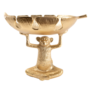 A gold-colored decorative bowl featuring a monkey figure.