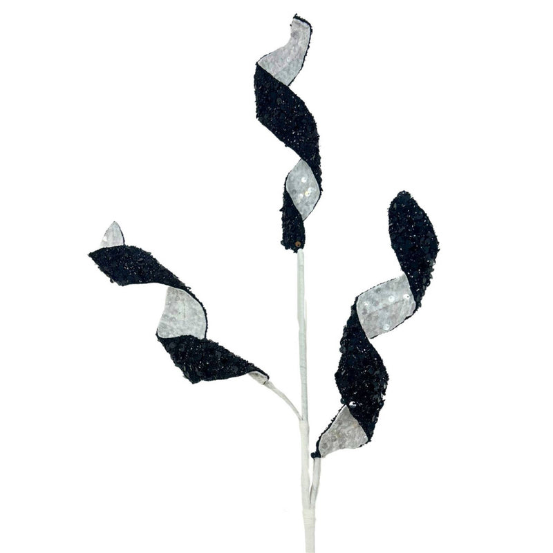 Decorative branch with black and silver leaves on a white background