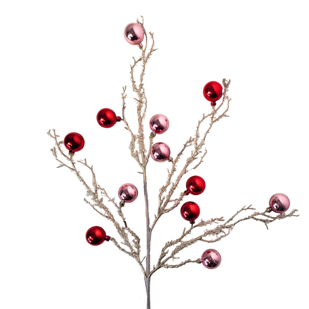 Decorative branch with red and pink spherical ornaments on a white background