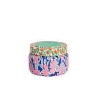 Colorful candle jar with floral design on a white background