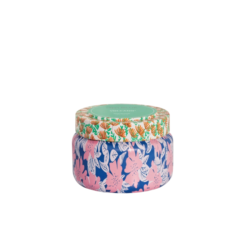 Colorful candle jar with floral design on a white background